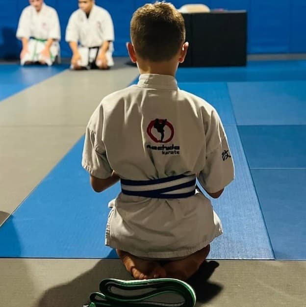 A young student kneeling in his Machida Karate gi at Patriot Martial Arts Academy